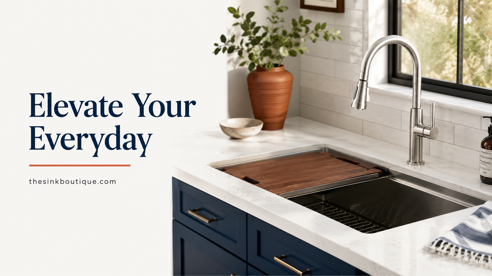 Stainless steel workstation kitchen sink with walnut cutting board and pull-down faucet, undermount in a white marble countertop over navy blue cabinets — The Sink Boutique stainless steel kitchen sink buying guide